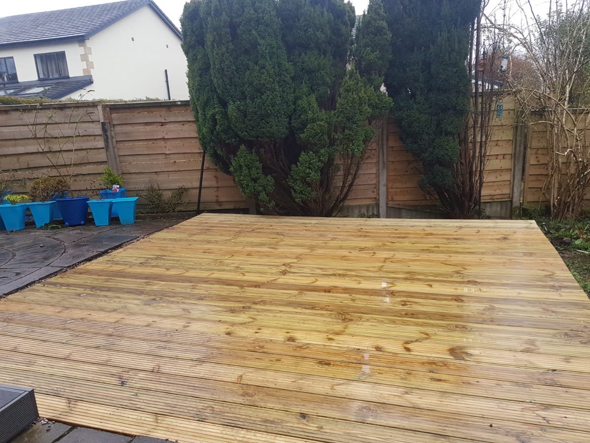 Timber decking with garden planting and hedge screening