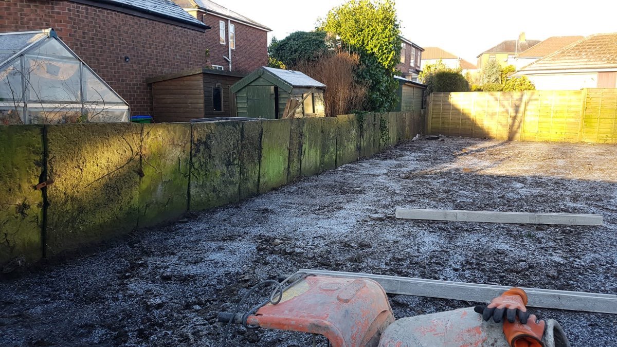 Timber sleeper retaining wall with garden fencing