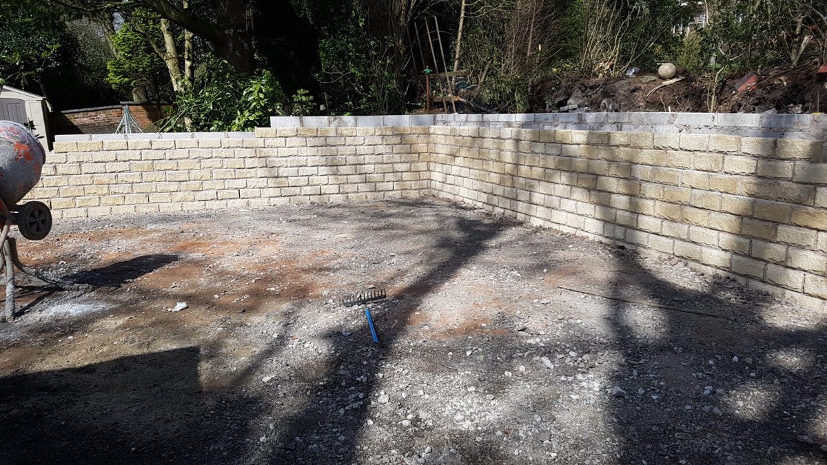 Curved buff-block retaining wall in a garden
