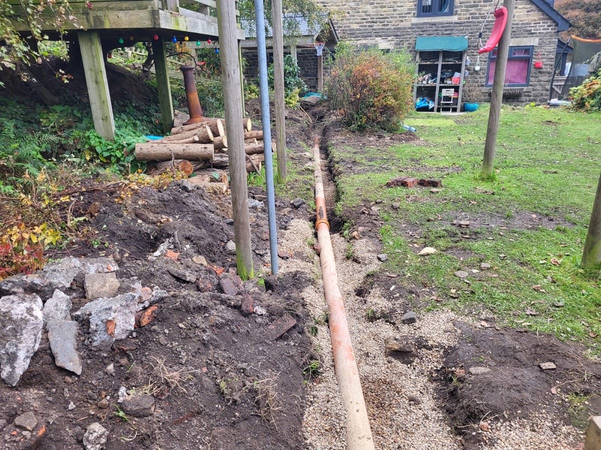 Land drainage pipework being installed