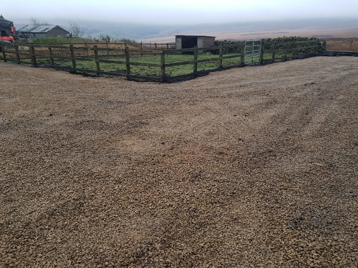 Rural gravel driveway with post and rail fencing