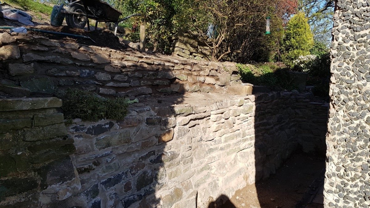 Dry stone retaining wall under construction